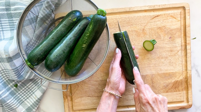 Person cutting a zucchini