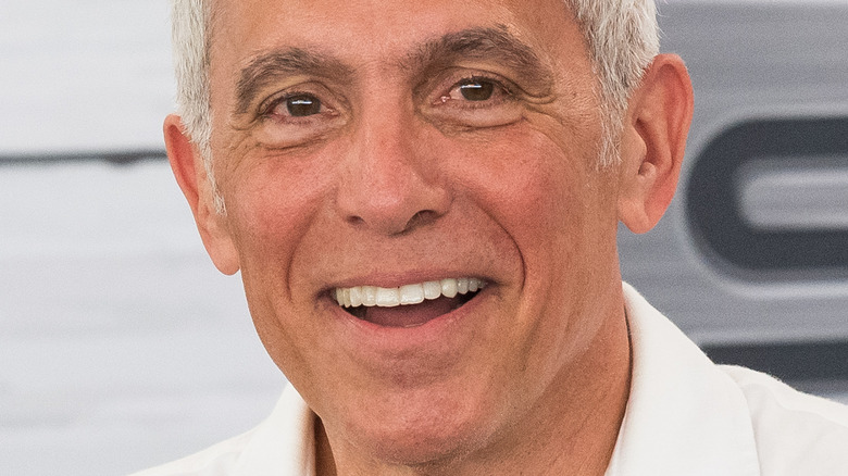 Geoffrey Zakarian smiing in a white collared shirt