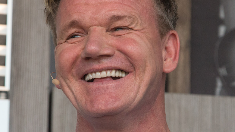 Gordon Ramsay with wide smile looking to the side