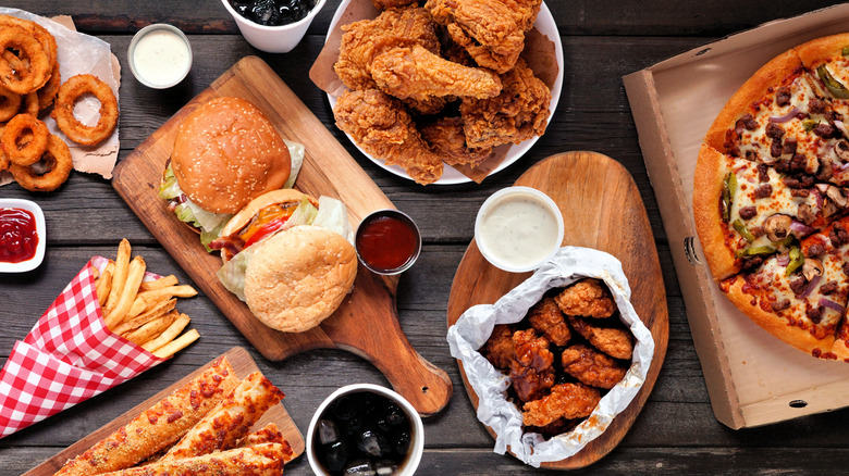large fast food order with burgers, fries, pizza, wings