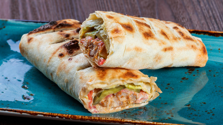 toasted burritos stacked on plate