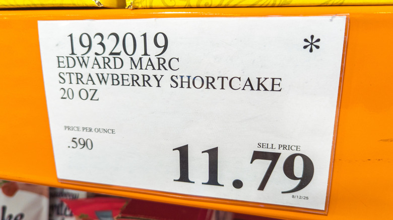 A price tag in a Costco for an Edward Marc strawberry shortcake priced at $11.79
