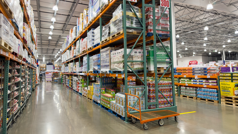 The interior of a Costco warehouse store with products in large cases on warehouse shelves