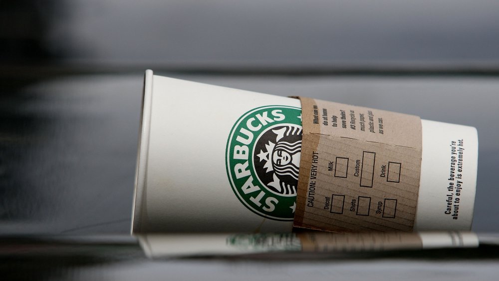 toppled empty hot starbucks cup 