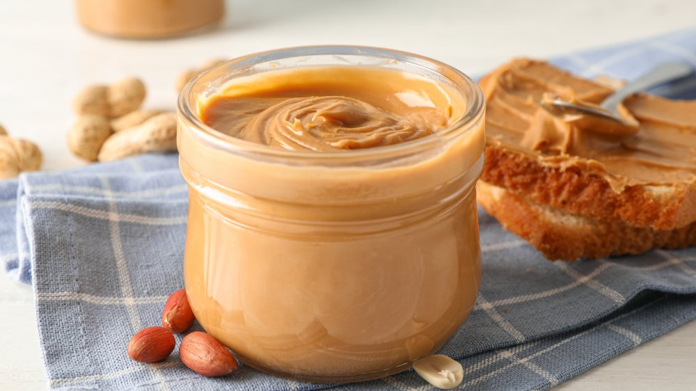 Peanut butter in a jar with toast