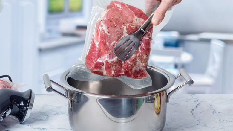 sous-vide steak going into pot