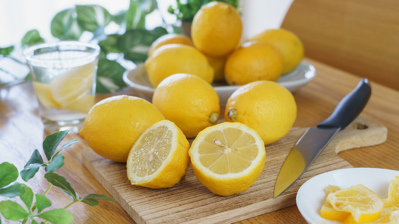 cut lemons and knife on cutting board