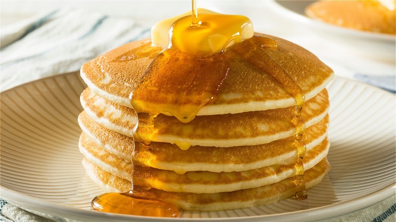 stack of pancakes with butter and syrup