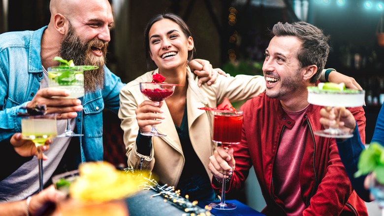 Friends enjoying drinks and smiling