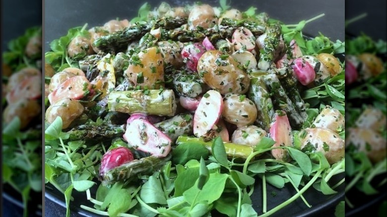 Potato salad with asparagus, radishes, greens