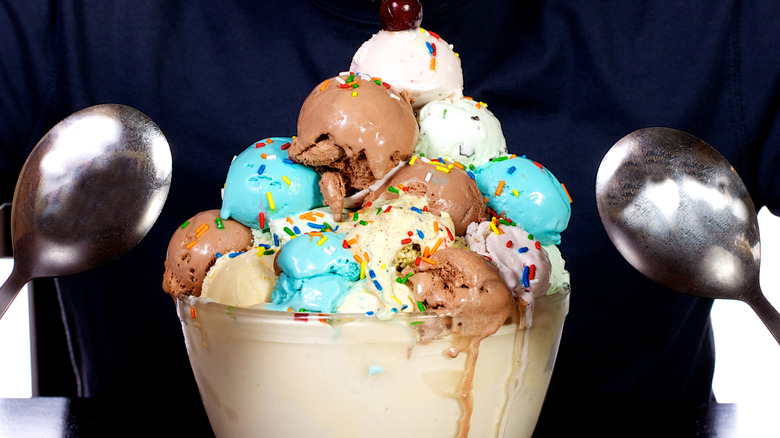Multiple scoops of ice cream in a large bowl, with spoons on each side of the bowl