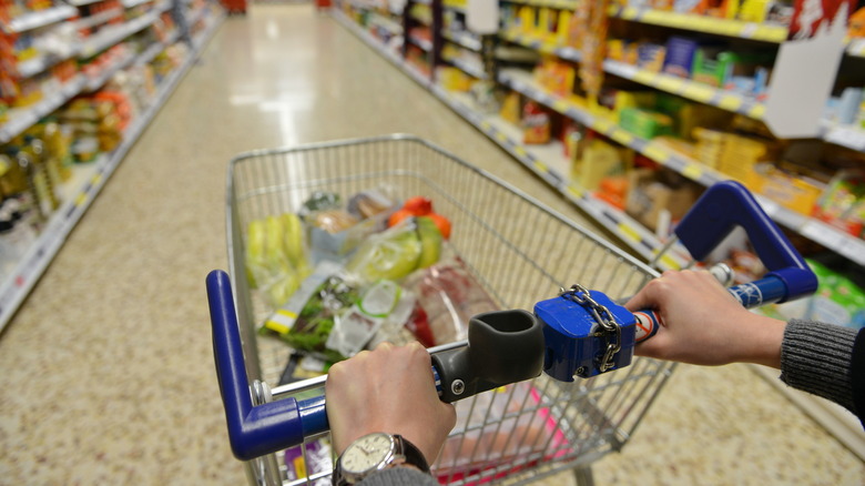 shopper pushes cart in Aldi