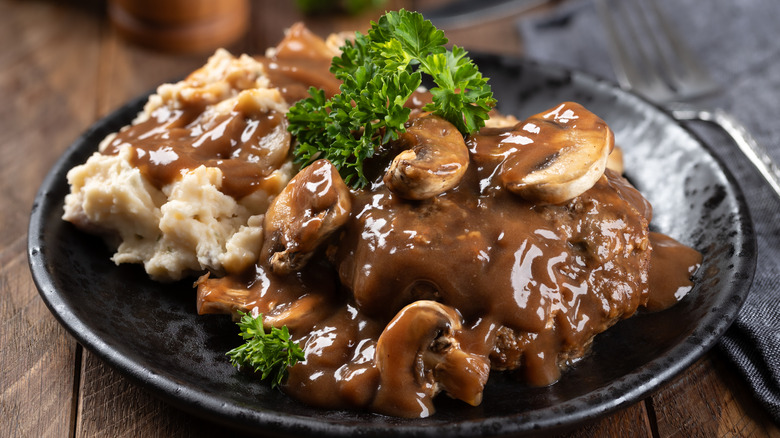 plate of Salisbury steak with mushrooms and mashed potatoes