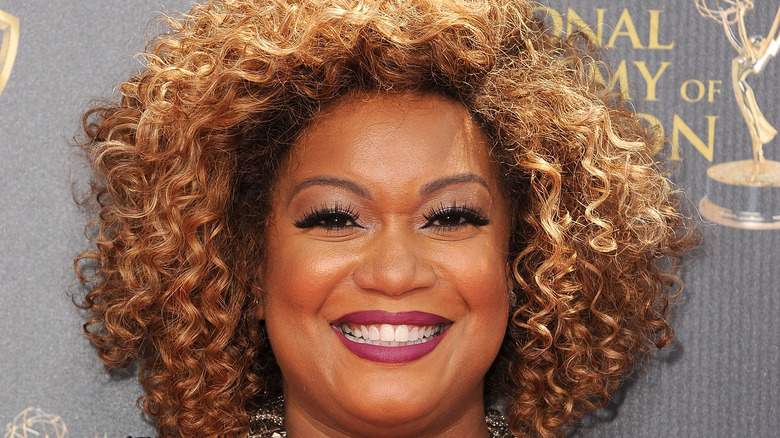 Sunny Anderson in plum-colored lipstick