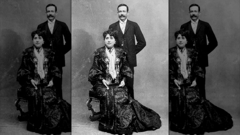 José Cuervo, with a thick mustache, stands behind his seated wife, Ana González Rubio, for a black and white portrait photograph.