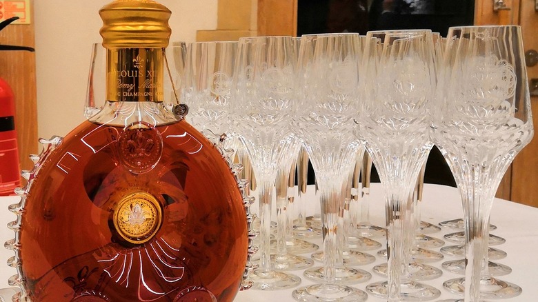 100-year-old Louis XIII cognac  bottle next to glasses
