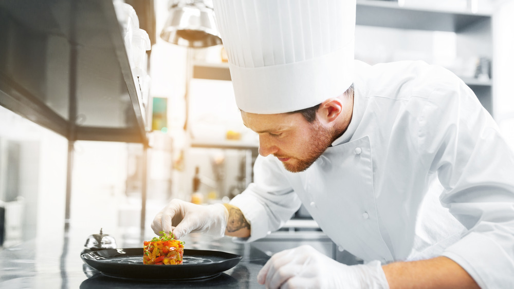 chef wearing a toque in a kitchen