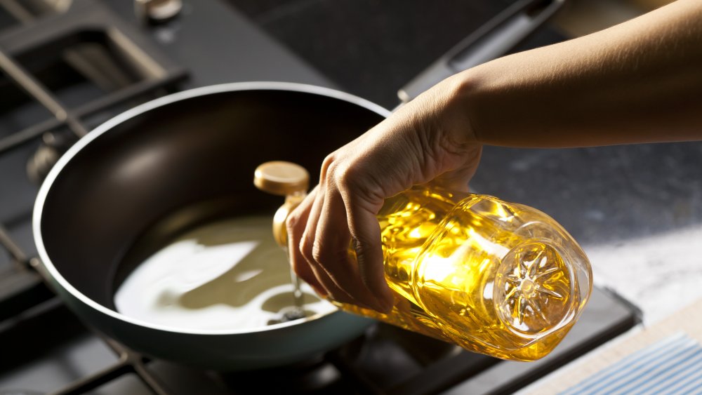 Pouring vegetable oil into a frying pan