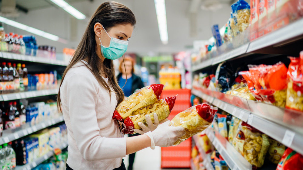 Person buying pasta mask gloves