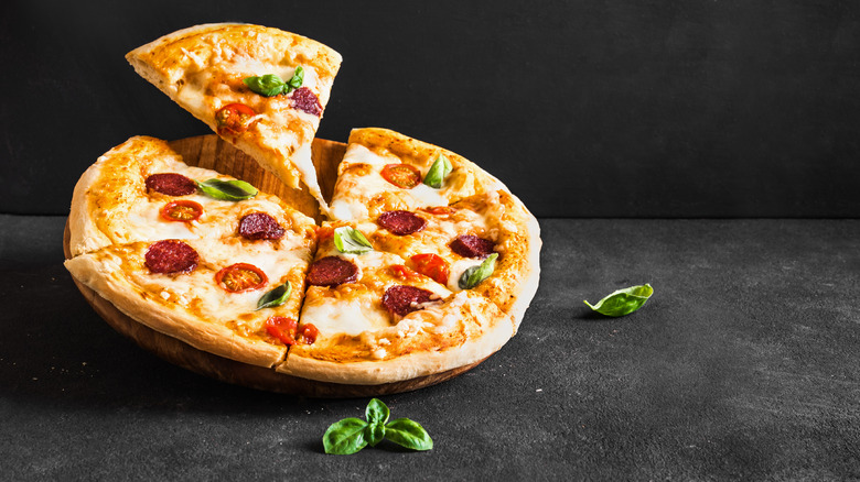 sliced pizza on cutting board