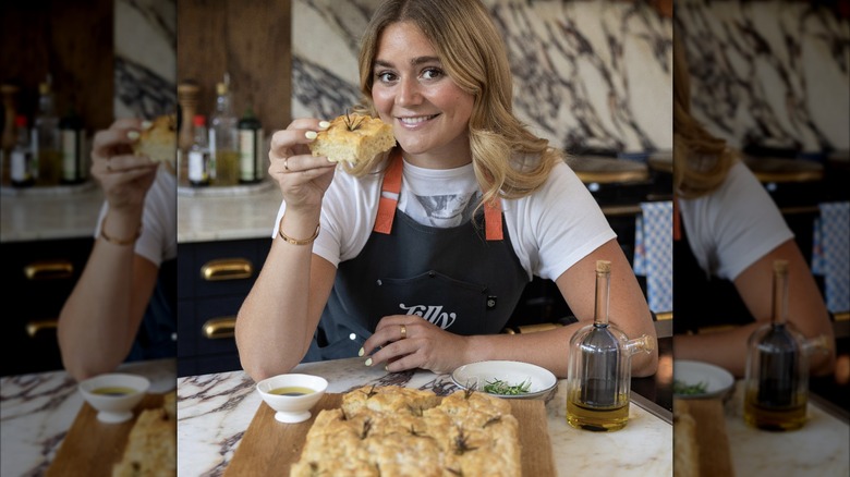 Tilly Ramsay holding slice of focaccia
