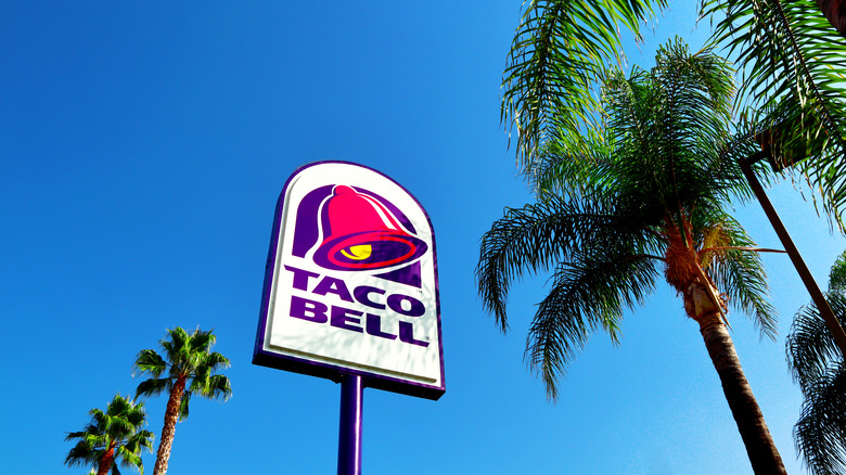 Taco Bell sign flanked by palm trees