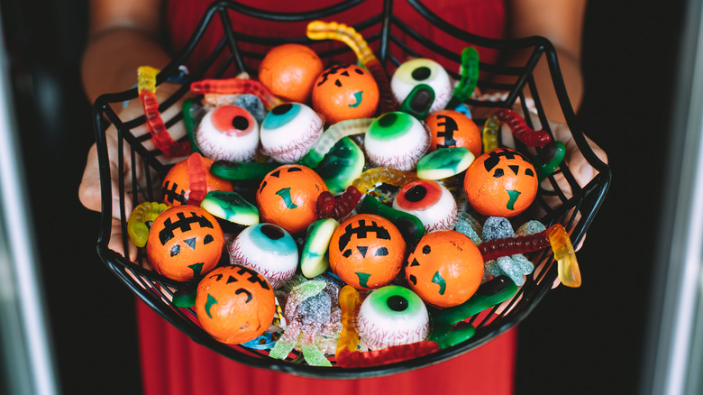 Women offering Halloween candy