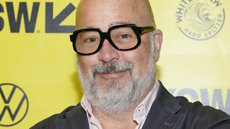 Andrew Zimmern with thick glasses and slight smile