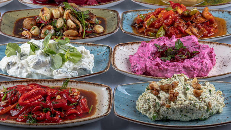 A buffet table with meze platters and dips