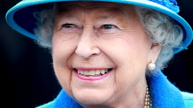 Queen Elizabeth wearing a blue hat