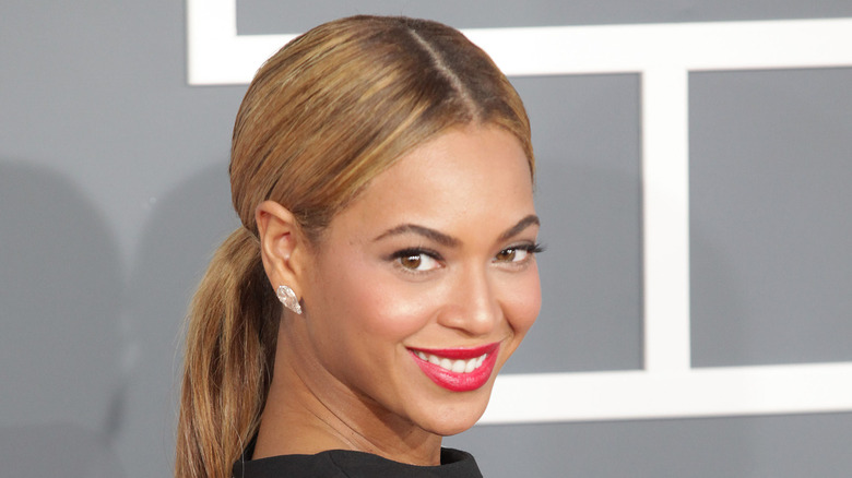 Beyoncé smiling and looking over her shoulder