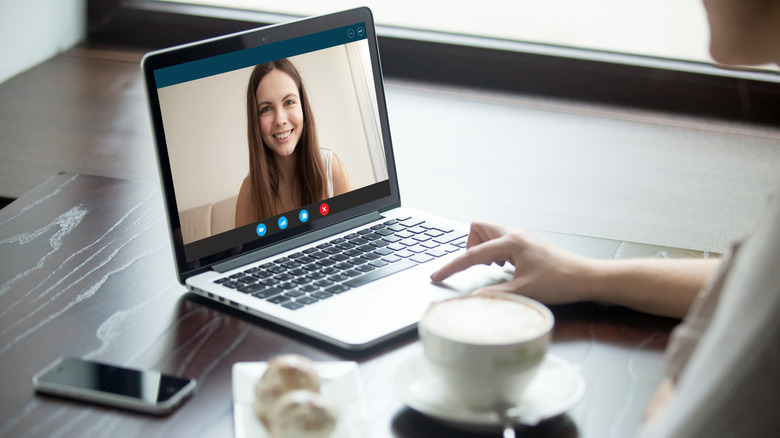 Person with webcam and coffee