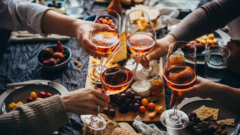Doing a cheers with wine