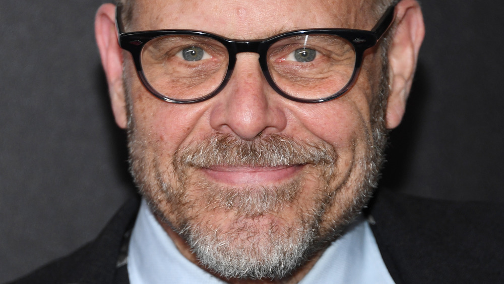 Alton Brown smiling with black glasses