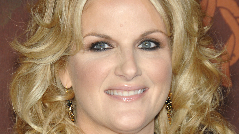 Trisha Yearwood smiles with curled hair