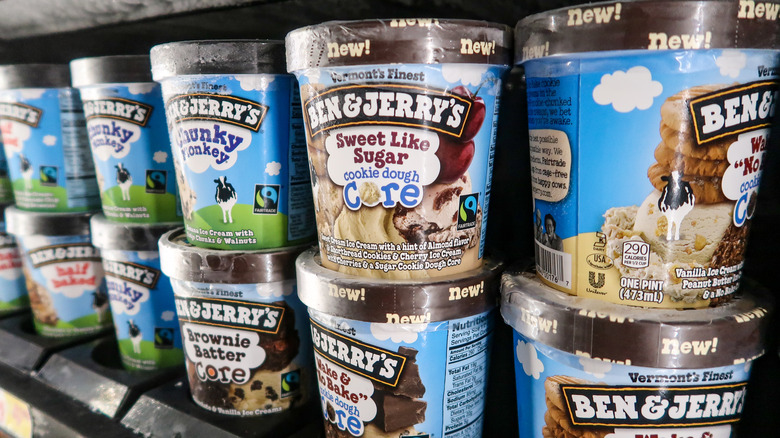 A row of frozen Ben & Jerry's ice cream pints in the frozen aisle of a store