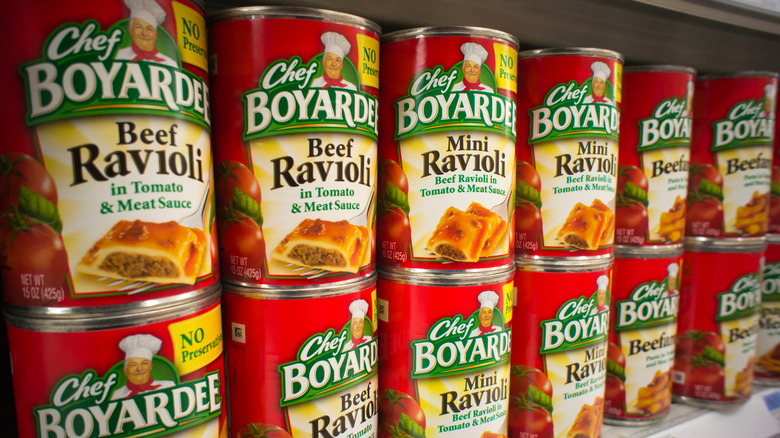 Cans of Chef Boyardee on a shelf