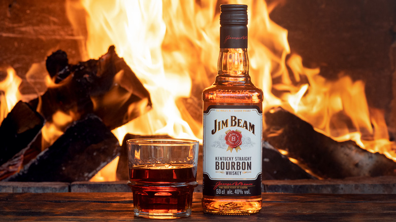 Bottle of Jim Beam by a fireplace