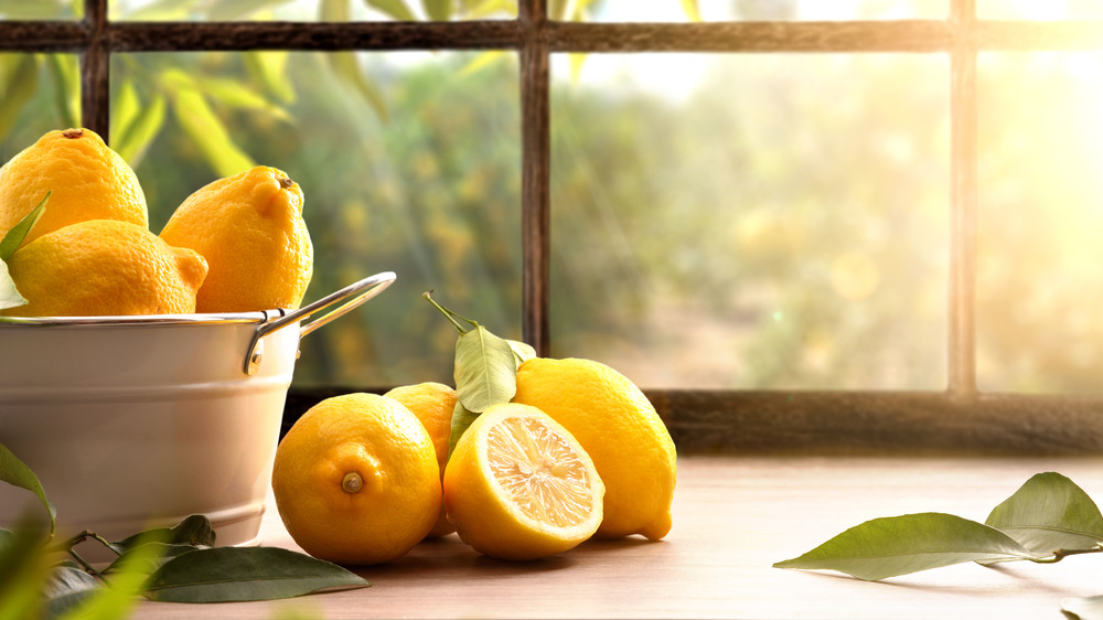 Basket of lemons on sunny table