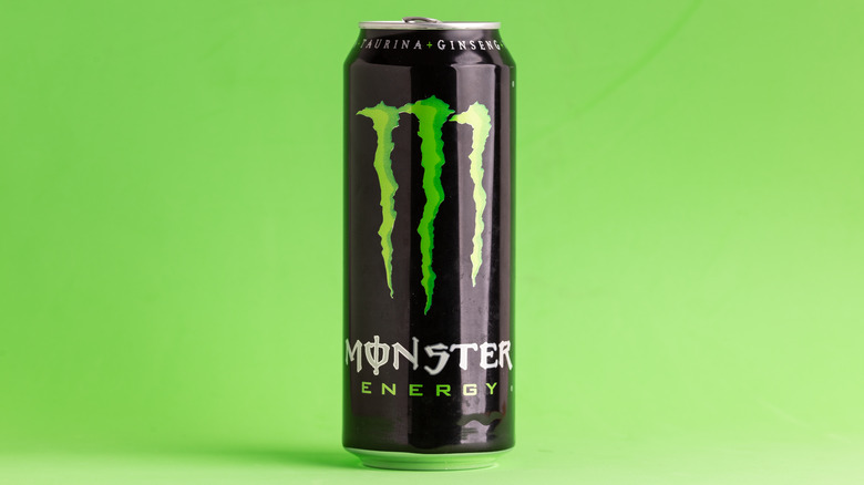 A can of Monster Energy Drink on green background