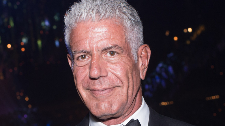 Anthony Bourdain holding Emmy award