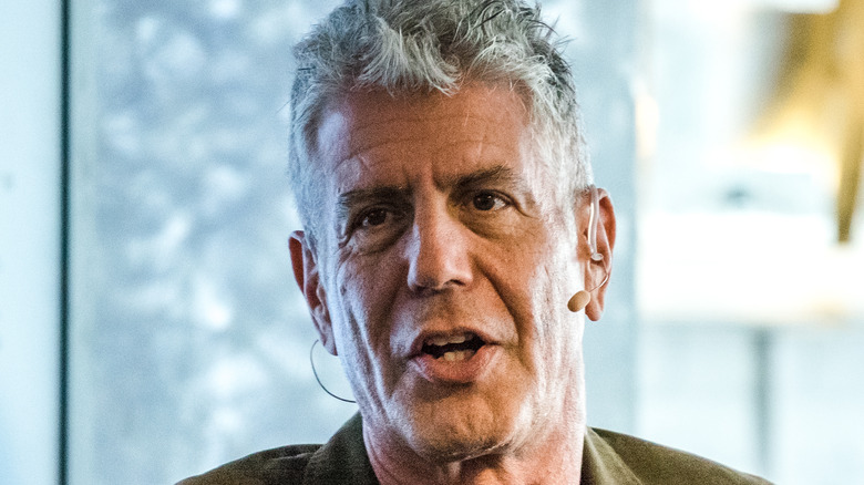 Anthony Bourdain speaking into headset