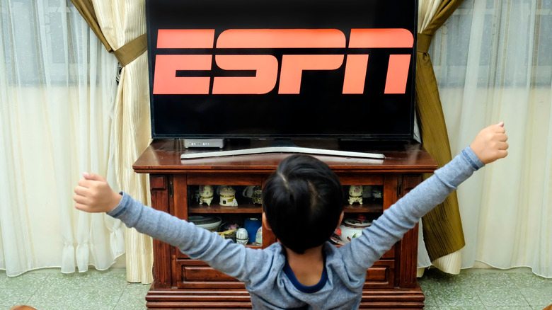 Kid watching ESPN on TV