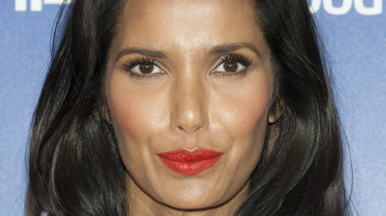 Padma Lakshmi smiles with red lipstick