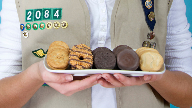 Girl scout holding cookies