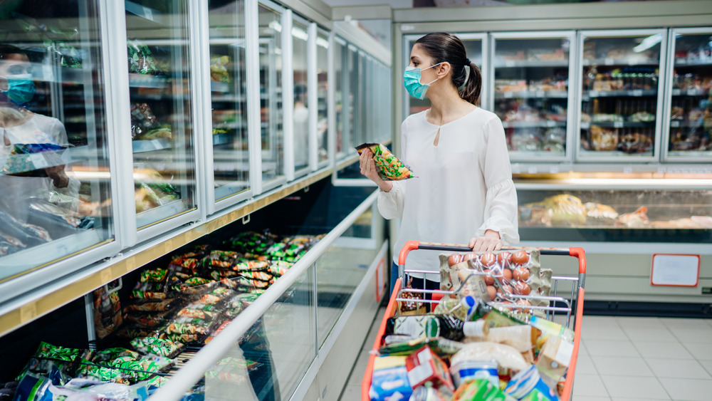 Woman in the supermarket freezer section