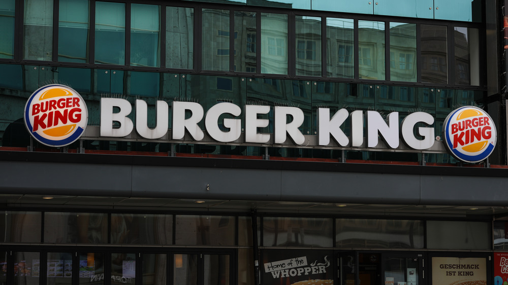 A Burger King sign against foliage 