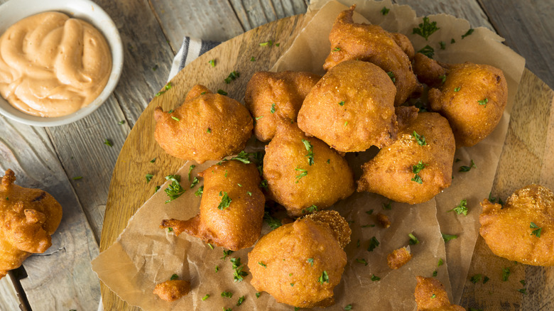 Hush puppies atop paper and wooden board