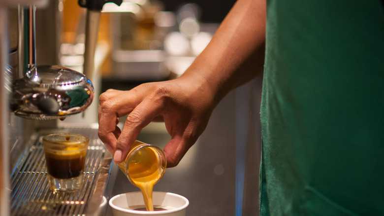 Starbucks barista pouring a shot of espresso