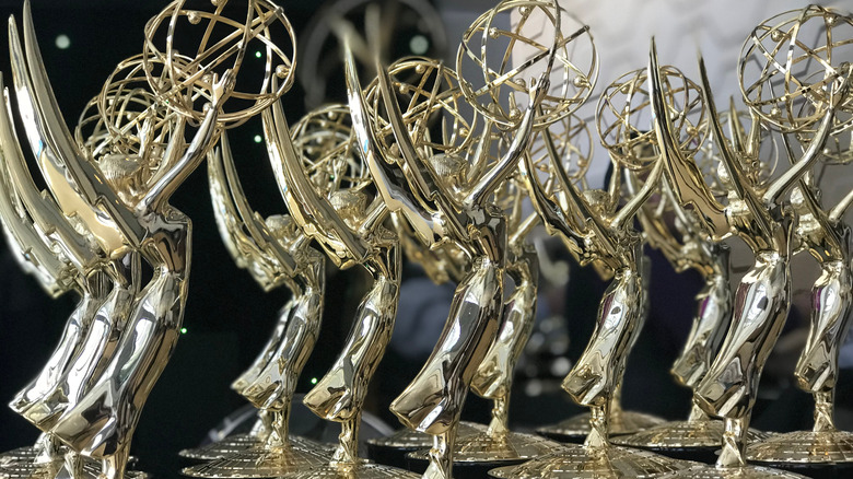 Multiple Emmy awards on a table